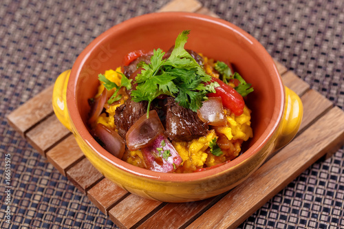 Grilled meat with raditional spanish rice decorated parsley