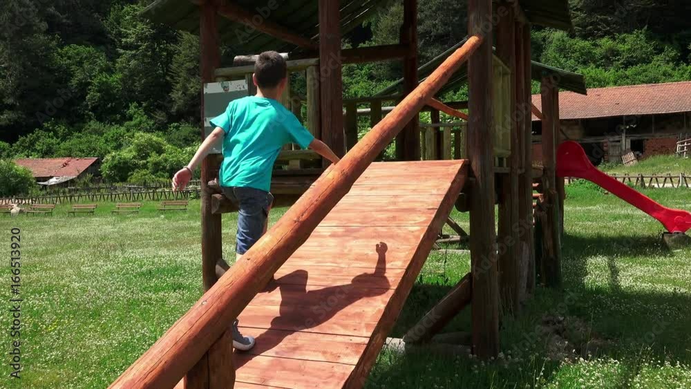 Excited boy in a Tree House Slideing Excited boy in a Tree House Slideing