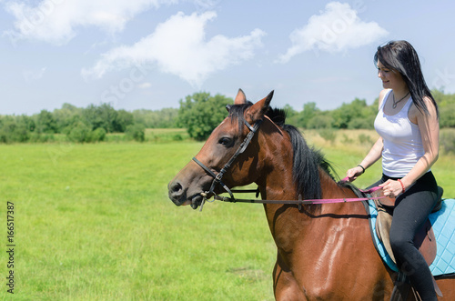 woman jockey training the horse on field