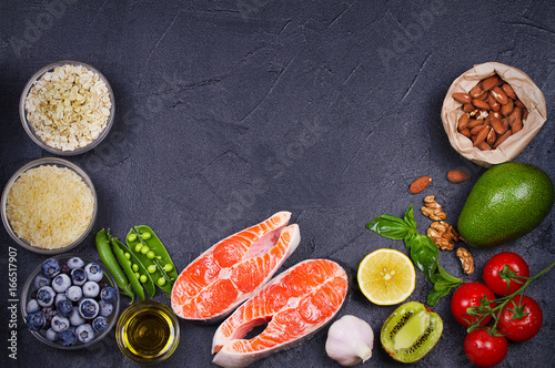 Detox healthy food concept with salmon fish, vegetables, fruits and ingredients for cooking. Selection of healthy and good for heart food. View from above, top studio shot