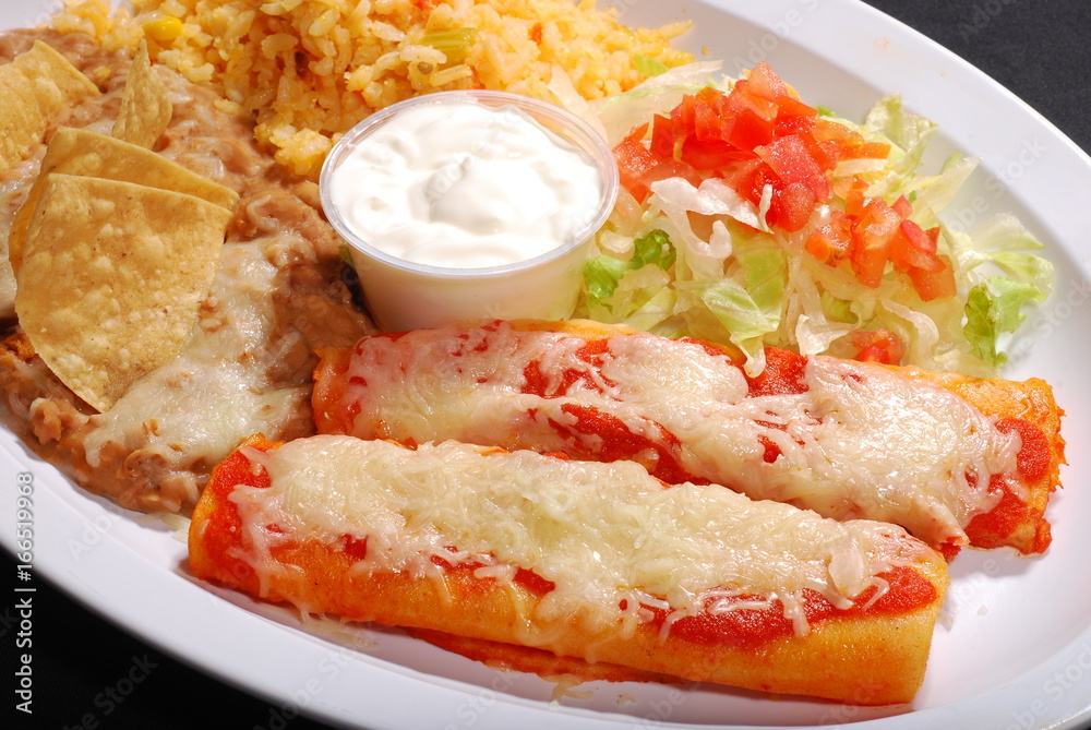 Red enchiladas with rice and beans, salad, cheese & sour cream, chips Red enchiladas with rice and beans, salad, cheese & sour cream, chips