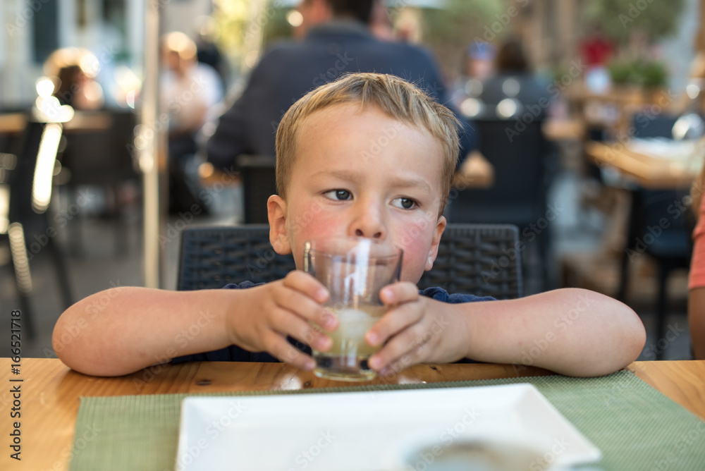 Little boy waiting for his lunch at restaurant Little boy waiting for his lunch at restaurant