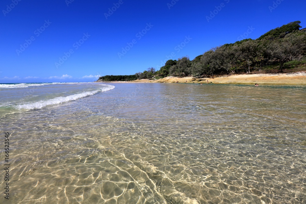 The crystal clear waters of Cylinder Beach on North Stradbroke Island in Queensland Australia