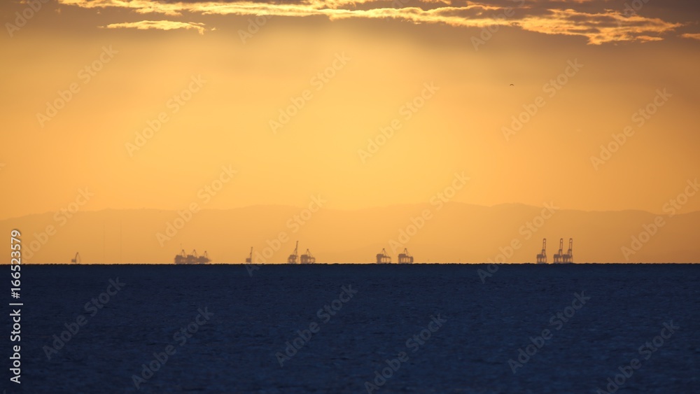 Sunset at the Port of Brisbane from North Stradbroke Island in Queensland Australia