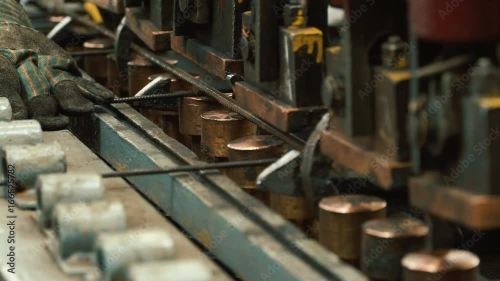 Manufacture of reinforced concrete structures. Production of metal wire products - automatic welding. Working part of machine. Close up Manufacture of reinforced concrete structures. Production of metal wire products - automatic welding. Working part of machine. Close up