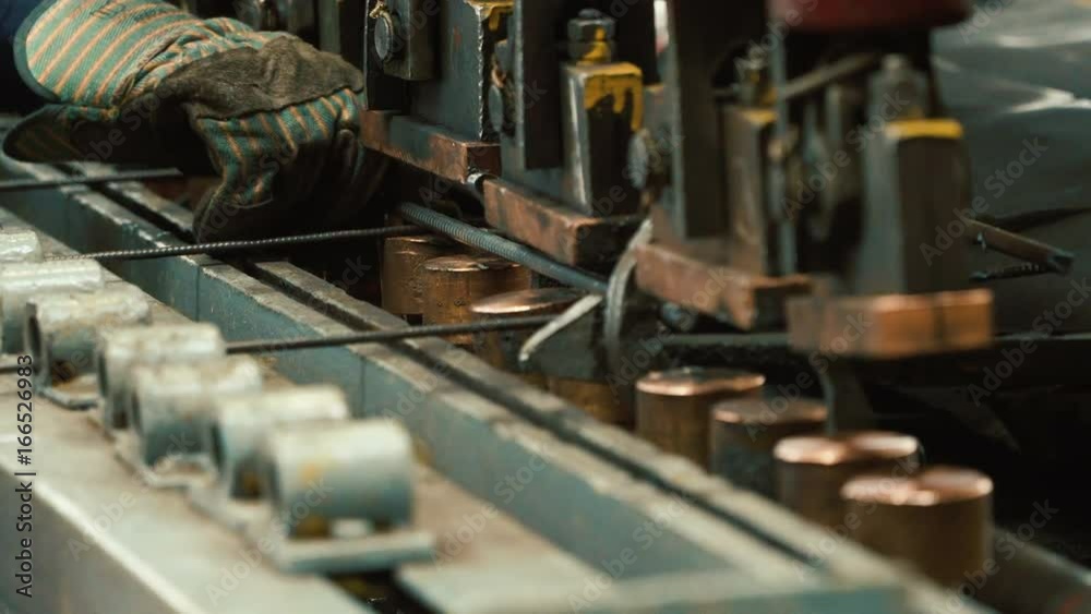 Manufacture of reinforced concrete structures. Production of metal wire products - automatic welding. Working part of machine. Close up Manufacture of reinforced concrete structures. Production of metal wire products - automatic welding. Working part of machine. Close up