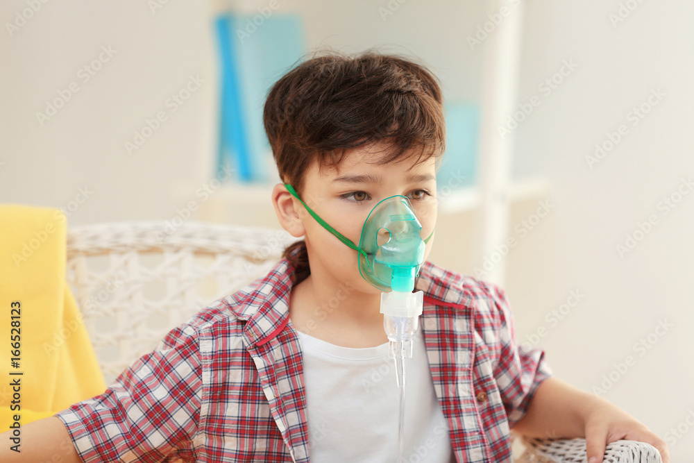 Boy using asthma machine at home