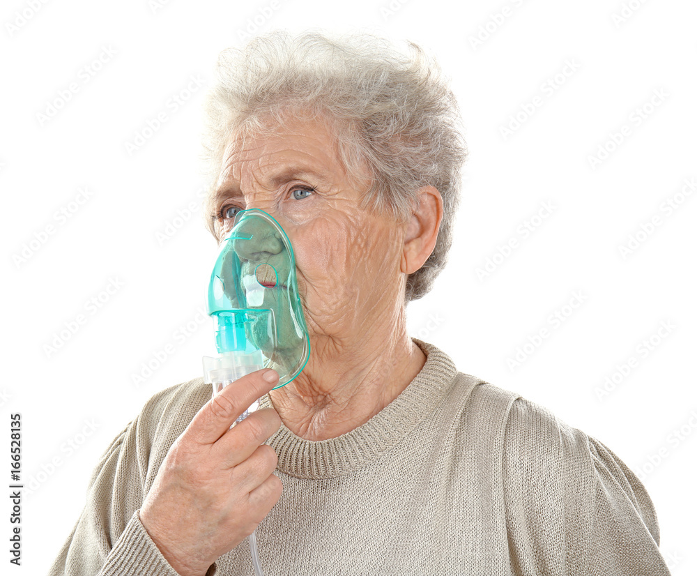 Elderly woman using asthma machine on white background Elderly woman using asthma machine on white background