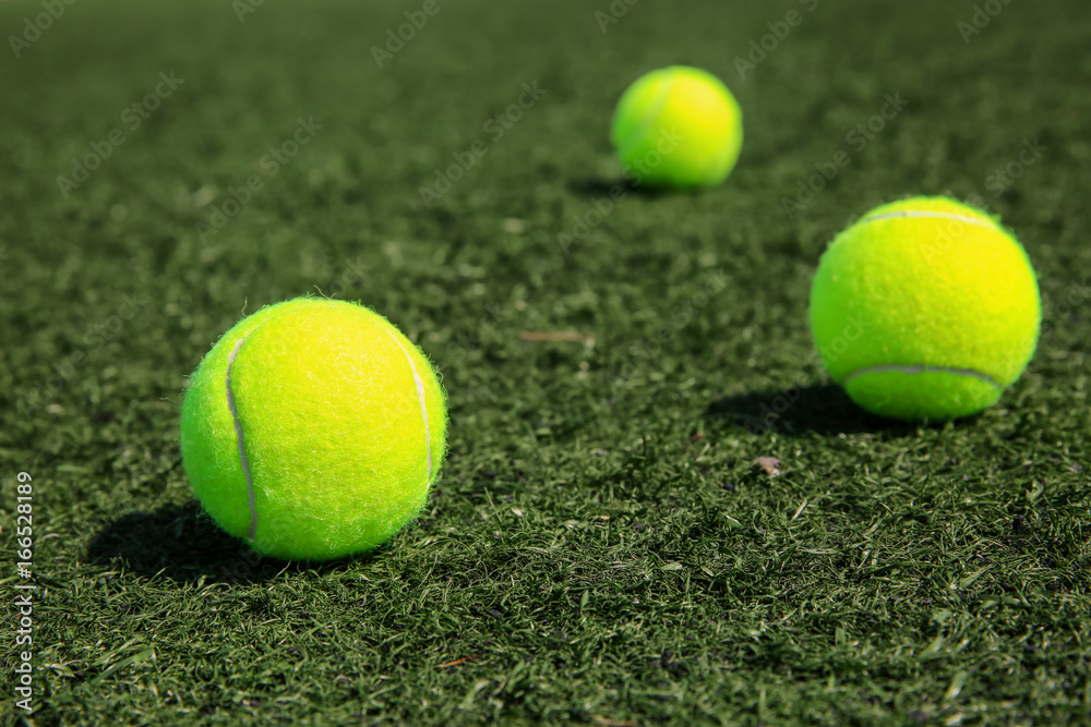 Tennis balls on fresh green grass outdoors