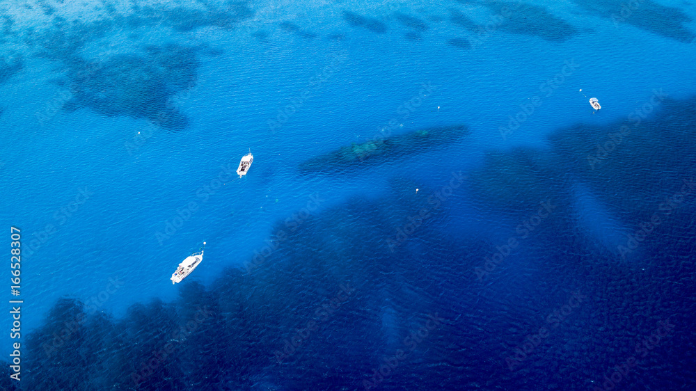 Fototapeta premium Dive boat and SCUBA divers over a large underwater shipwreck