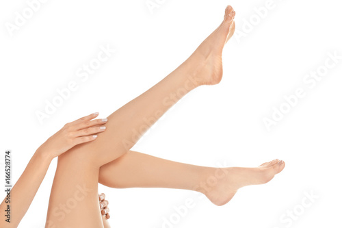 Epilation concept. Legs and hands of beautiful young woman on white background