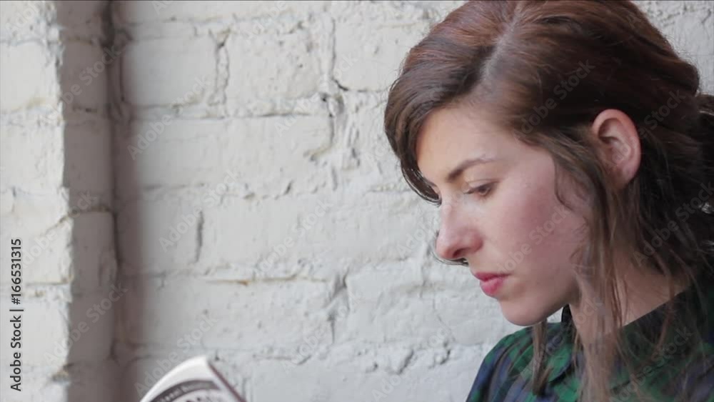 Profile of a woman reading in a cafe Profile of a woman reading in a cafe