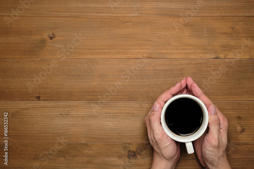 Male hands holding cups of coffee