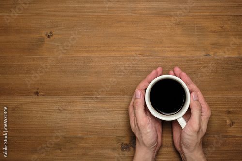 Male hands holding cups of coffee