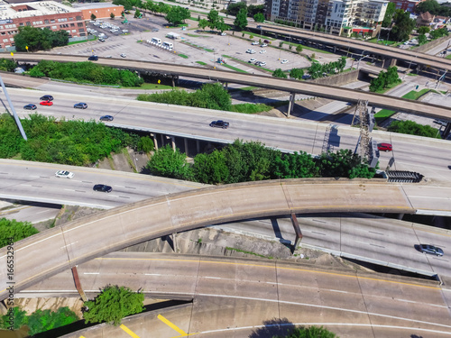 Aerial top view highway I45 (Gulf Freeway), asphalt elevated road and Bayou River in downtown Houston, Texas, US. Passenger cars and trucks are commuting at daytime. Urban transportation publication.