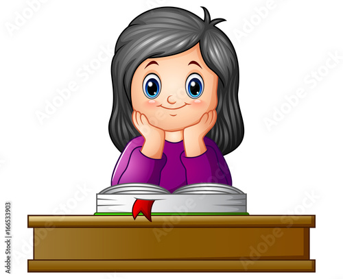 School girl with textbook at desk