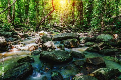 deep forest waterfall on mountain and sunshine in thailand