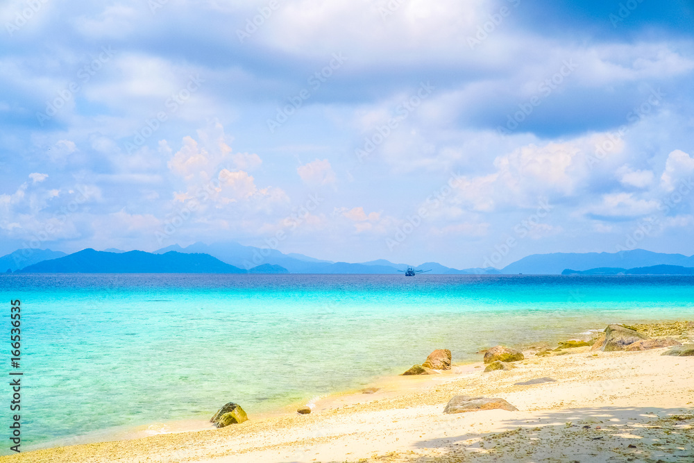 Sea view from tropical beach with sunny sky. Summer paradise beach of island. Exotic summer beach with clouds on horizon.