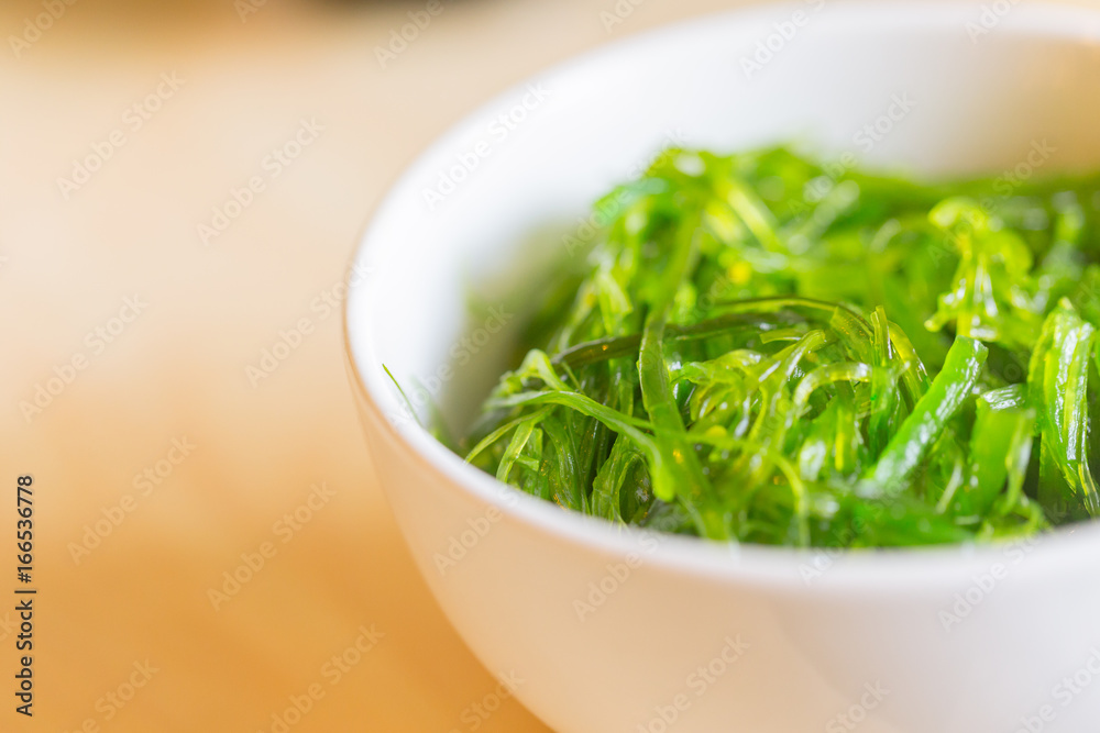 seaweed salad. Japanese healthy food from sea served in bowl on wood table with space for text. seaweed salad. Japanese healthy food from sea served in bowl on wood table with space for text.