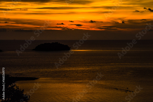 Beautiful blazing sunset landscape at black sea and orange sky above it. Amazing summer sunset view on the beach.