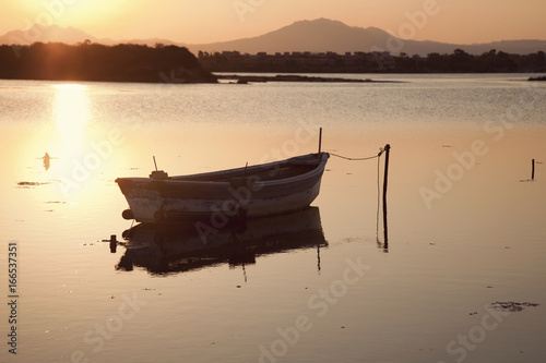 Fishing boat in the lake at the sunset