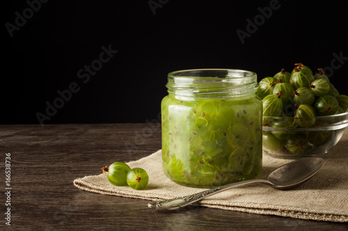 Gooseberry smoothie in a jar on a brown table