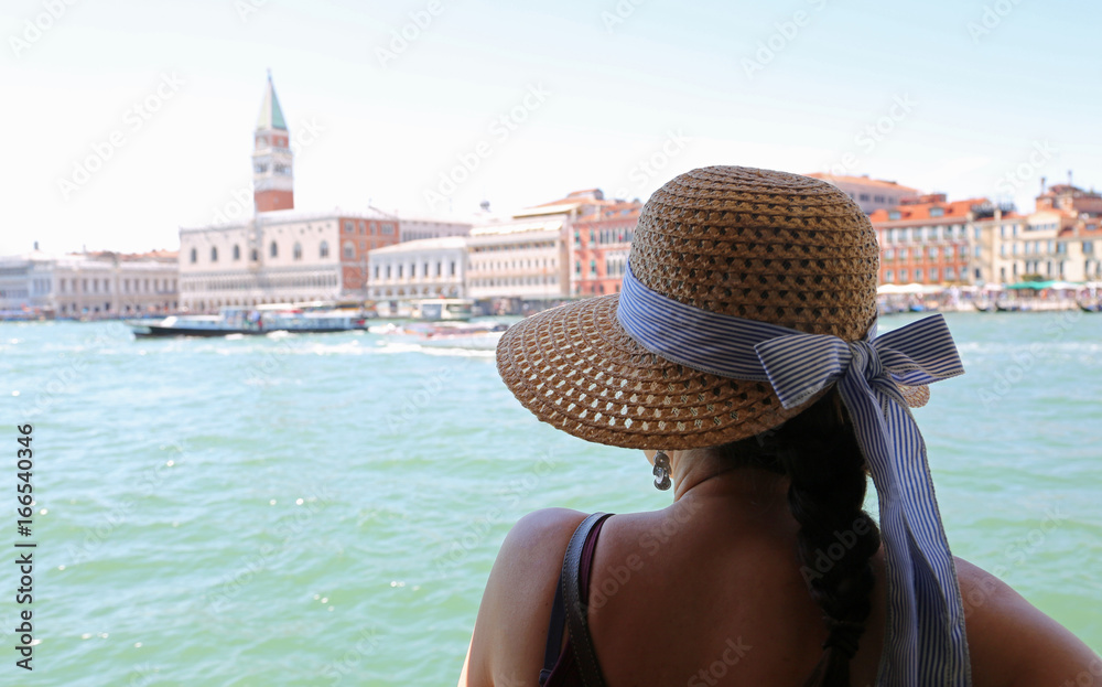 Rich woman with straw hat in tourist sight in the city of Venice