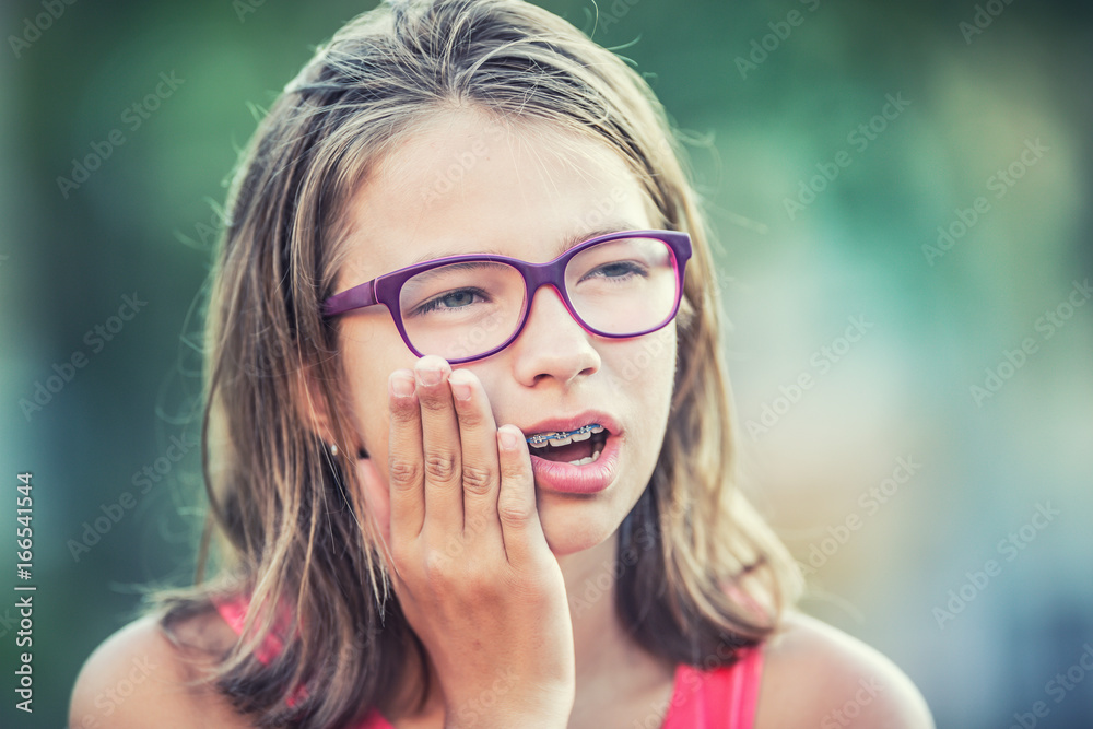 Portrait of young teen girl with toothache. Girl with dental braces and  glasses фотография Stock | Adobe Stock