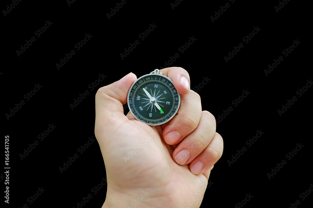 Compass in hand isolated on black background. Compass in hand isolated on black background.
