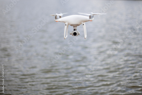 Drone fly at high speed on a sky above the water