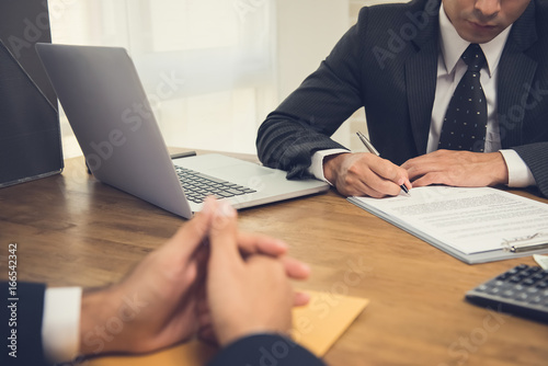 Businessman signing agreement contract with his partner