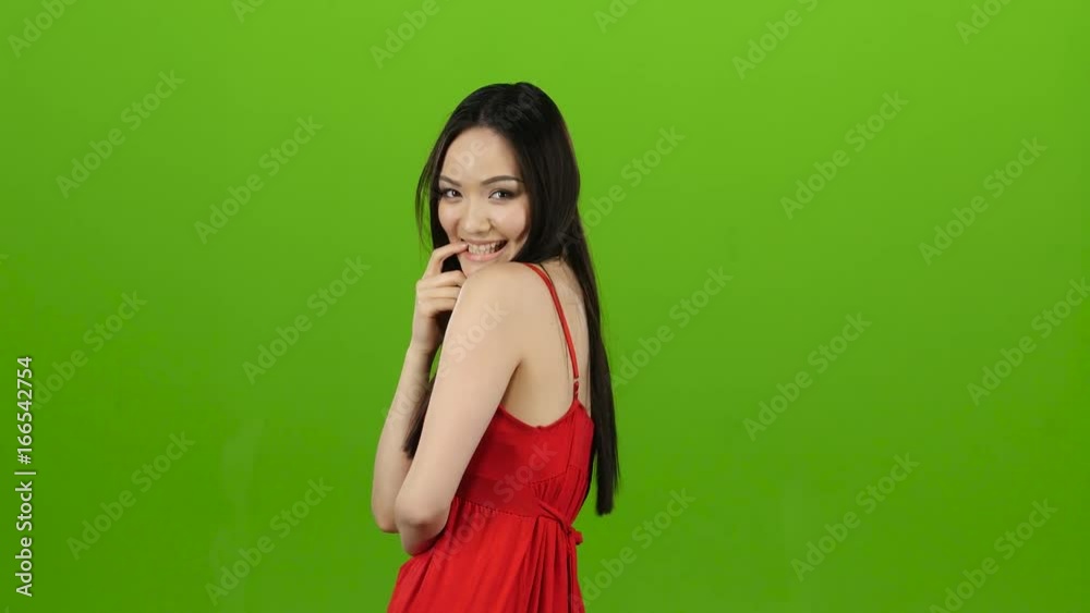 Girl is posing in front of the cameras, winking. Green screen Girl is posing in front of the cameras, winking. Green screen
