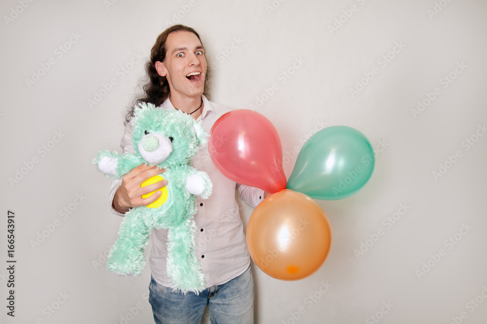 Fototapeta premium handsome romantic man with teddy bear gift on white background isolated