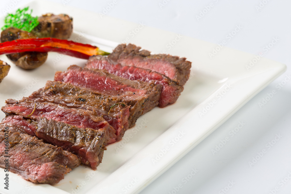Juicy steak medium rare beef with spices and grilled vegetables