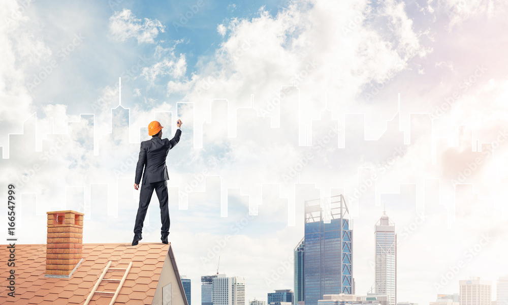Man architect draw silhouette of modern city on blue sky. Mixed Man architect draw silhouette of modern city on blue sky. Mixed