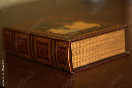 ancient old books on a wooden table with textured editing 