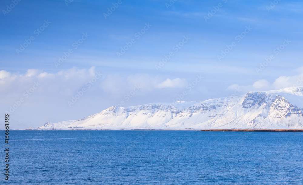Icelandic coastal landscape with snowy mountains