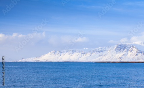 Icelandic coastal landscape with snowy mountains © evannovostro