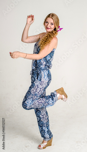 Beautiful romantic girl blonde in summer dress with orchid flower
