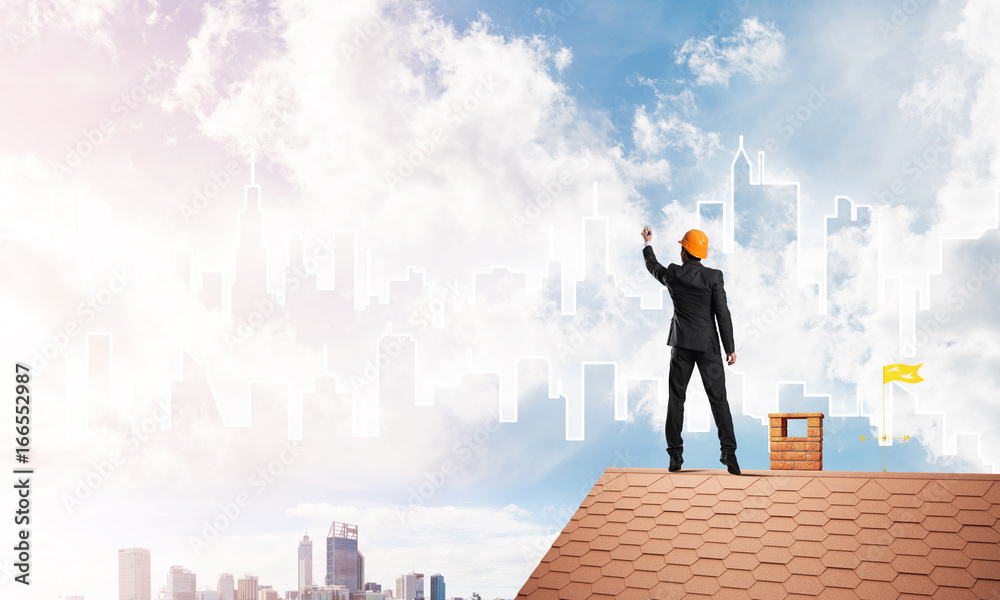 Man architect draw silhouette of modern city on blue sky. Mixed media Man architect draw silhouette of modern city on blue sky. Mixed media