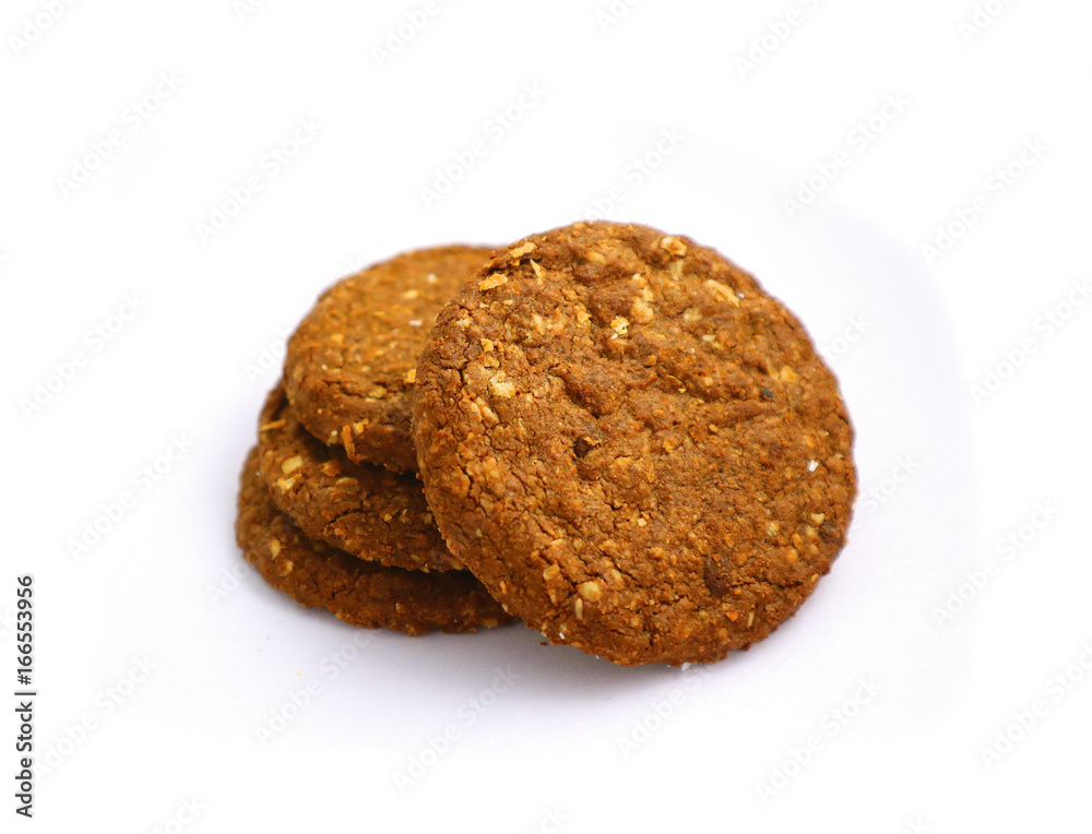 A pile of four healthy brown detailed cereal chocolate cookies. .Cereal roundish cookies, vegan breakfast consent. Macro, close up view.
