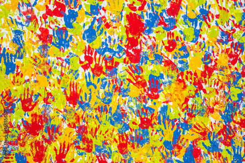 Seamless hands background isolated on white - teamwork concept. Imprint of the children's palm on the canvas. Prints of colored hands. Many children's colorful hands.