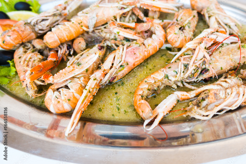 Cooked Scampi Prawns Shrimps in white wine sauce with garlic and parsley, closeup, isolated Cooked Scampi Prawns Shrimps in white wine sauce with garlic and parsley, closeup, isolated