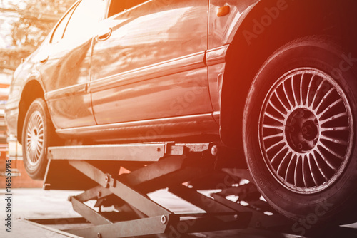 Car lifted in automobile service for fixing, repair, changing and maintenance in garage