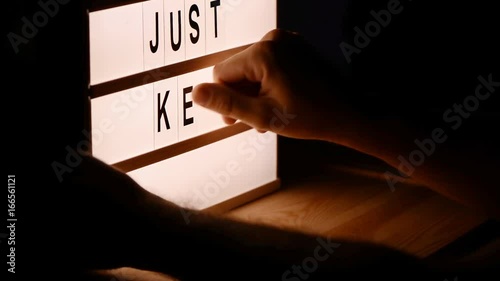 Just keep trying, motivational message on lightbox photo