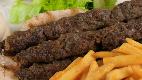 Turkish food, meat kebab with fresh vegetables and french fries, loop, 4K, ProRes codec, 422 HQ, ISO 100