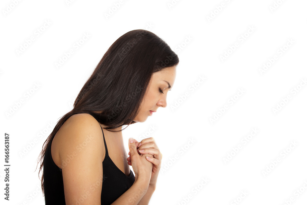 Portrait of a young praying woman with long hair in profile Portrait of a young praying woman with long hair in profile