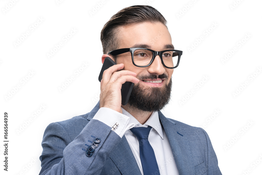 portrait of handsome smiling businessman in grey suit using smartphone, isolated on white portrait of handsome smiling businessman in grey suit using smartphone, isolated on white