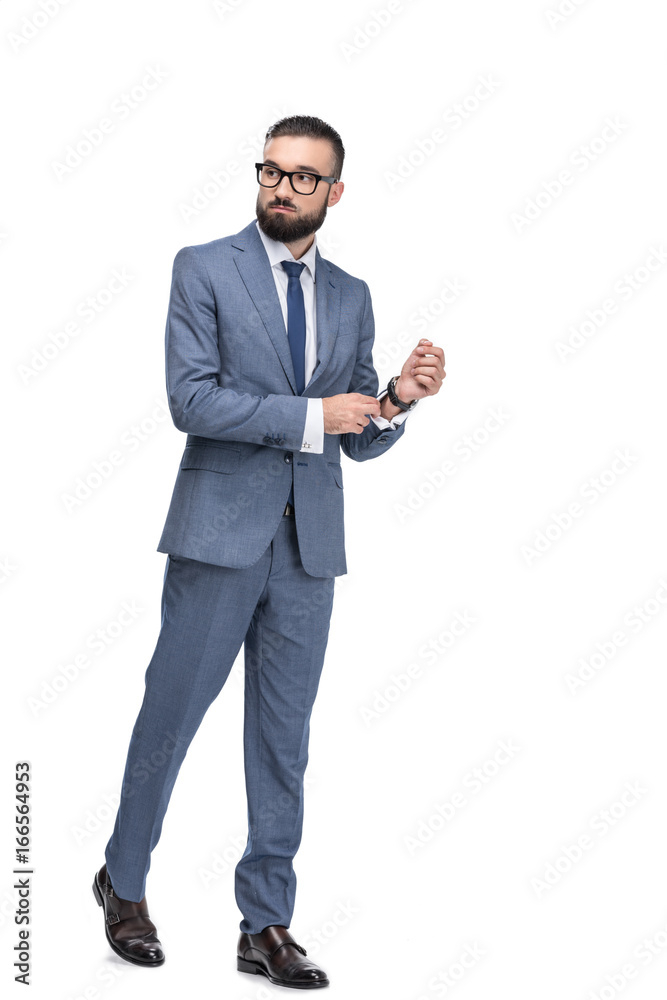Obraz premium confident handsome businessman posing in grey suit, isolated on white