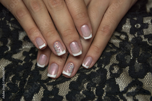 Lacquer on the nails of the hands. Fresh French manicure